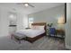 Bedroom with a king-size bed, desk, and ensuite bathroom, offering comfort and functionality at 1523 Corolla Ct, Reunion, FL 34747