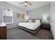 Bright bedroom with a ceiling fan, stylish decor, a bed with white linens and a window at 1523 Corolla Ct, Reunion, FL 34747