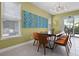 Bright dining area featuring a long table with seating, and decorative light fixture at 1523 Corolla Ct, Reunion, FL 34747