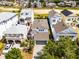 Aerial view of home showcasing a paver driveway and mature landscaping at 1523 Corolla Ct, Reunion, FL 34747