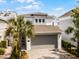 A modern, well-maintained home with an attached garage, stone facade and meticulous landscaping at 1523 Corolla Ct, Reunion, FL 34747