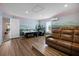 Entertainment room with golf-themed mural, wood floors, seating area and an air hockey table at 1523 Corolla Ct, Reunion, FL 34747