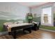 Bright game room with air hockey, golf arcade game, wood floors and golf themed mural at 1523 Corolla Ct, Reunion, FL 34747