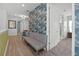 Hallway with stylish seating, a decorative wall, and access to multiple rooms, creating a welcoming space at 1523 Corolla Ct, Reunion, FL 34747