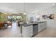 Open-concept living area with a kitchen island and stainless steel appliances, seamless indoor/outdoor flow at 1523 Corolla Ct, Reunion, FL 34747