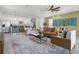 Open concept living area with modern furnishings and seamless flow into the kitchen at 1523 Corolla Ct, Reunion, FL 34747