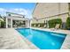 Relaxing backyard swimming pool with sun loungers, hot tub and view of the property at 1523 Corolla Ct, Reunion, FL 34747