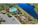 Aerial view of community amenities including a pool, playground, and parking area at 15604 Starlite St, Clermont, FL 34714