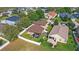 Aerial view of a well-maintained backyard with a screened patio and white fence at 15604 Starlite St, Clermont, FL 34714