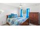 Bedroom with wood furniture, large window and blue bedding at 15604 Starlite St, Clermont, FL 34714