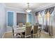 Stylish dining room featuring a modern table setting, decorative wall panels, and elegant window treatments at 15604 Starlite St, Clermont, FL 34714