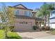 Well-maintained two-story home with a brick driveway, lush landscaping, and a welcoming facade at 15604 Starlite St, Clermont, FL 34714