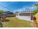 Backyard with a gray shed, wood fence, and patchy grass at 1563 Immocalee St, Intercession City, FL 33848