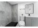 Bathroom with gray tiled shower, gray vanity, and black hardware at 1563 Immocalee St, Intercession City, FL 33848