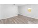 Empty bedroom with wood-look flooring, white walls, and a window at 1563 Immocalee St, Intercession City, FL 33848