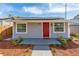 Charming home with a bright red door and recently landscaped front yard at 1563 Immocalee St, Intercession City, FL 33848