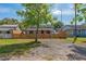 Quaint single-story home with a red door, framed by a charming wooden picket fence at 1563 Immocalee St, Intercession City, FL 33848