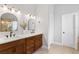 Neutral bathroom featuring a double sink vanity with dark cabinets and sconce lighting at 1667 Spring Loop Way, Winter Garden, FL 34787