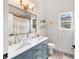 Stylish bathroom featuring double sinks, gold hardware and a large mirror at 1667 Spring Loop Way, Winter Garden, FL 34787