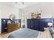 Comfortable bedroom featuring blue accent walls, wood floors, and a window at 1667 Spring Loop Way, Winter Garden, FL 34787