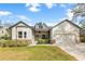 Attractive home with white siding, stone details, manicured lawn, and a convenient two-car garage at 1667 Spring Loop Way, Winter Garden, FL 34787