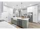 Bright kitchen featuring a large island, stainless steel appliances, and a modern farmhouse sink at 1667 Spring Loop Way, Winter Garden, FL 34787