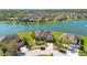 Stunning aerial view of waterfront home with pool, lush landscaping, and serene lake backdrop at 1730 Boat Launch Rd, Kissimmee, FL 34746