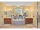 Primary bathroom featuring a soaking tub, double vanity, and glass block window at 1730 Boat Launch Rd, Kissimmee, FL 34746