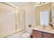 Bright bathroom featuring a shower-tub combination with sliding glass doors and a white vanity at 1730 Boat Launch Rd, Kissimmee, FL 34746