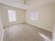 Bright bedroom featuring two windows, a ceiling fan, and light-colored wood-look flooring at 1762 Philadelphia Ct, Deltona, FL 32725