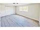 Light-filled bedroom with wood-look floors, a closet, and two windows at 1762 Philadelphia Ct, Deltona, FL 32725