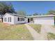 Charming single-story home with a well-maintained yard, black shutters and a walkway leading to the front door at 1762 Philadelphia Ct, Deltona, FL 32725