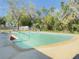 Refreshing outdoor pool with a diving board and lush greenery in the background at 1762 Philadelphia Ct, Deltona, FL 32725