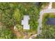 Aerial view showing the home's location amidst a lush, green landscape with water features at 1800 Johnson Dr, Clermont, FL 34711