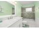 Nicely tiled bathroom with a shower and bath at 1800 Johnson Dr, Clermont, FL 34711