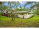 Exterior view showcasing the home's architecture and its surrounding lush greenery at 1800 Johnson Dr, Clermont, FL 34711