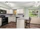 Bright kitchen with stainless steel appliances and bar stool seating at 1800 Johnson Dr, Clermont, FL 34711