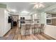 Spacious kitchen featuring white cabinets, stainless appliances, and bar stool seating at 1800 Johnson Dr, Clermont, FL 34711