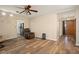 Cozy living room features wood-look floors, a ceiling fan, and easy access to the kitchen at 1800 Johnson Dr, Clermont, FL 34711