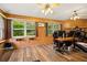 Home office area featuring wood paneled walls, wood-look flooring, and great natural light at 1800 Johnson Dr, Clermont, FL 34711