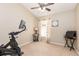 Minimalist bedroom featuring neutral walls, natural light, and exercise equipment at 2109 Carpathian Dr, Apopka, FL 32712