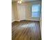 Cozy bedroom featuring wood-look floors, natural light, and a closet at 2533 Grassy Point Dr # 113, Lake Mary, FL 32746