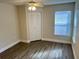 Bedroom with wood-look floors, a closet, and a view of the outside at 2533 Grassy Point Dr # 113, Lake Mary, FL 32746