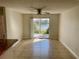 Bright dining area featuring ceramic tile floors, fan and sliding glass doors with a view of the lake at 2533 Grassy Point Dr # 113, Lake Mary, FL 32746