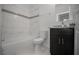 Modern bathroom featuring marbled tile surround, a dark vanity, and a granite countertop at 2681 Sw 161St Loop, Ocala, FL 34473
