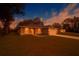 Charming single story home featuring a manicured lawn, attached garage, and beautiful evening sky at 2681 Sw 161St Loop, Ocala, FL 34473