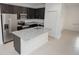 A modern kitchen features dark cabinets, stainless steel appliances, and granite countertops at 2681 Sw 161St Loop, Ocala, FL 34473