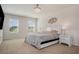 Bedroom featuring neutral carpet, a bed with gray bedding, two windows and accent lighting at 2736 Dumont Ln, Tavares, FL 32778