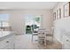 Bright dining area with a white table and chairs, adjacent to sliding glass doors leading to the backyard at 2736 Dumont Ln, Tavares, FL 32778