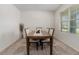 Formal dining room featuring a dark wood table, six chairs, and a window for natural light at 2736 Dumont Ln, Tavares, FL 32778